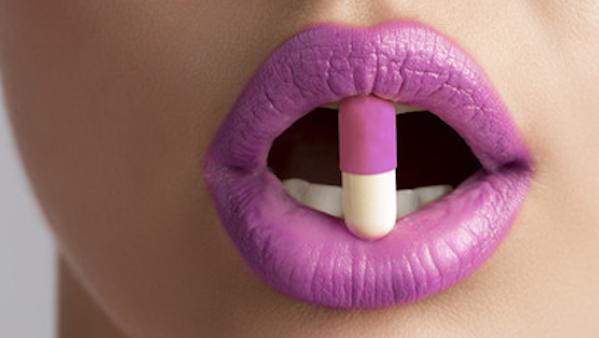 sexy female mouth with pill