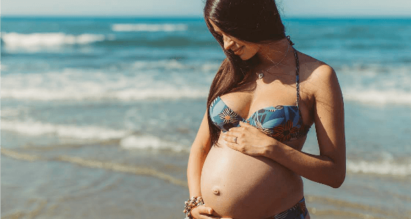 Pregnant Woman On Beach